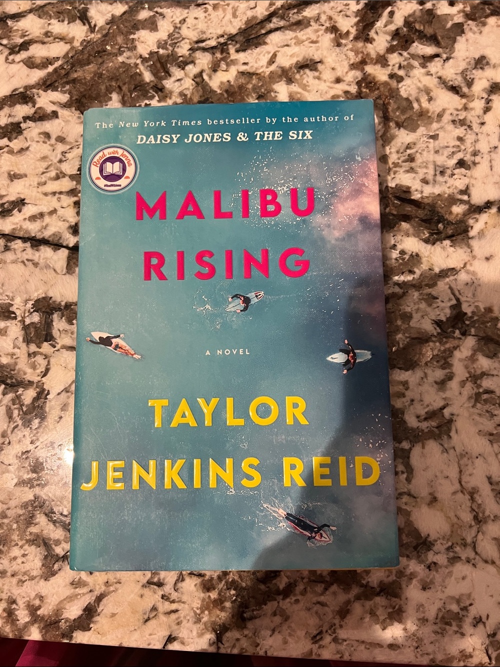Malibu Rising by Taylor Jenkins Reid - Blue Cover with Pink & Yellow Text